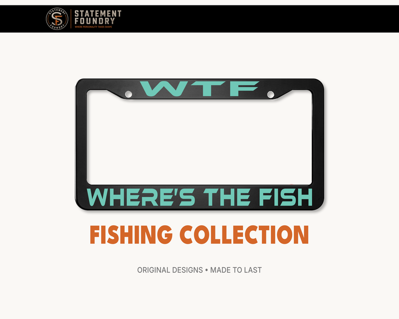 Black metal license plate frame featuring turquoise “WTF” lettering and “WHERE'S THE FISH” in bold lettering.